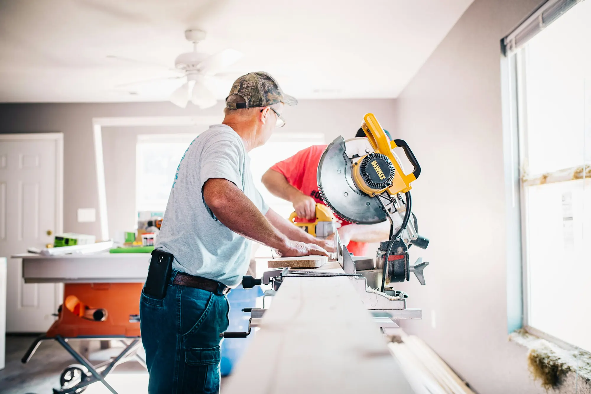 A contractor cutting trim during an interior remodel