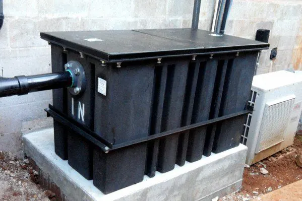 A tank set and plumbed on a new concrete pad